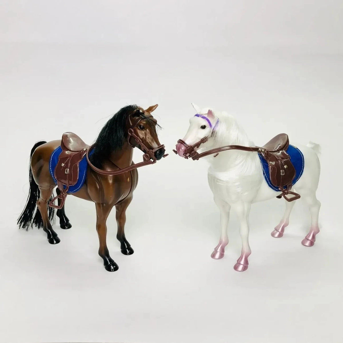 A brown and white horse figurine with a blue saddle and riding prop accessory.