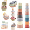 A set of boat-shaped stacking cups and bath toys for toddlers in various pastel colors.
