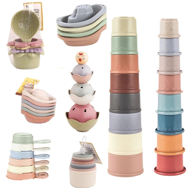 A set of boat-shaped stacking cups and bath toys for toddlers in various pastel colors.