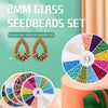 A set of 2mm glass seed beads in various colors displayed on a white circular plate for jewelry making