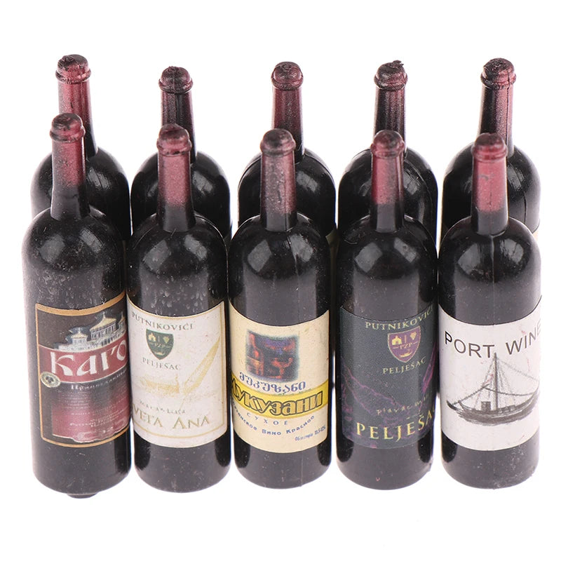 A set of miniature resin wine bottles with dark liquid and corks for dollhouse decor