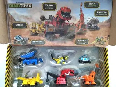 A box of Dinotrux toys featuring various dinosaur truck figures and removable dinosaur characters.