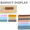 A display of various leather-style handmade with love tags in different colors and designs for crafts and sewing.