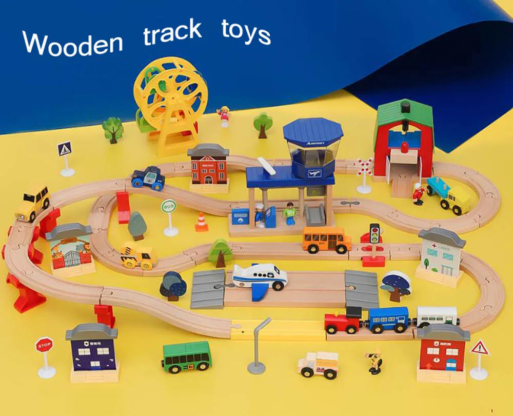 A set of wooden train track toys featuring various scenes like an airport and gas station with different vehicles and structu