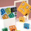A set of wooden face-changing cube puzzle toys in various colors and shapes displayed on a white surface.