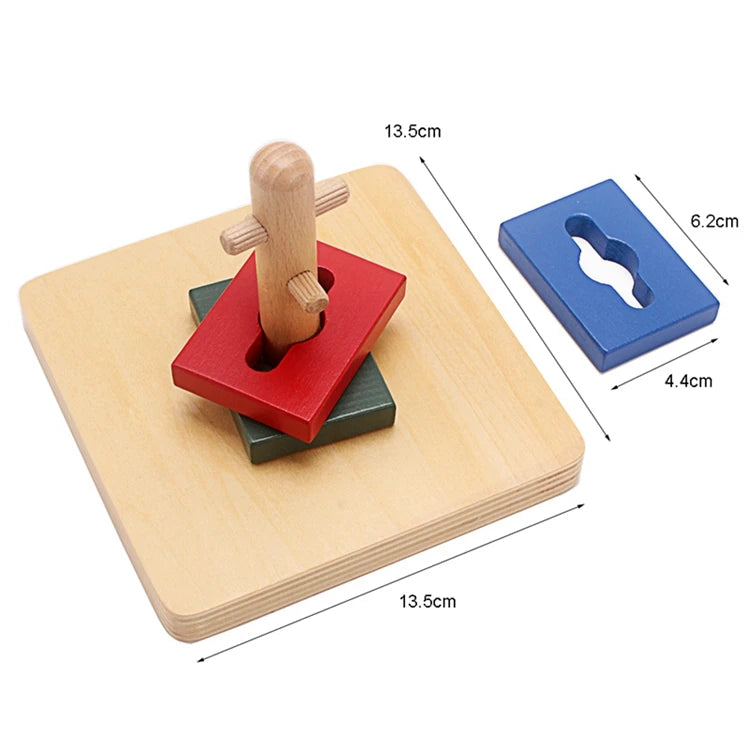 A wooden Montessori sensory toy set featuring a red block, a green base, and a wooden dowel on a light wood board.