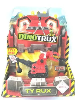 A Dinotrux dinosaur truck toy car with removable dinosaur figures displayed in its packaging.