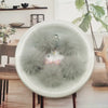 A white bowl filled with fluffy gray mink fur pom poms for crafts and accessories