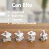 A set of natural wooden screw and nut building blocks for toddlers shown on a wooden surface.