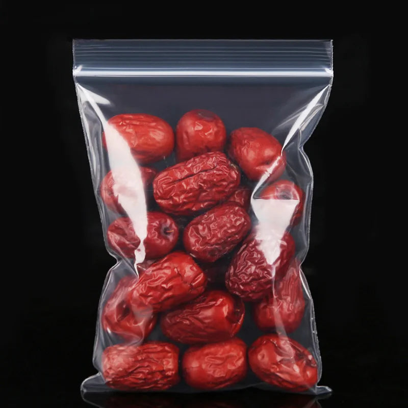 A clear resealable plastic bag filled with dried red fruit, likely jujubes or similar items.
