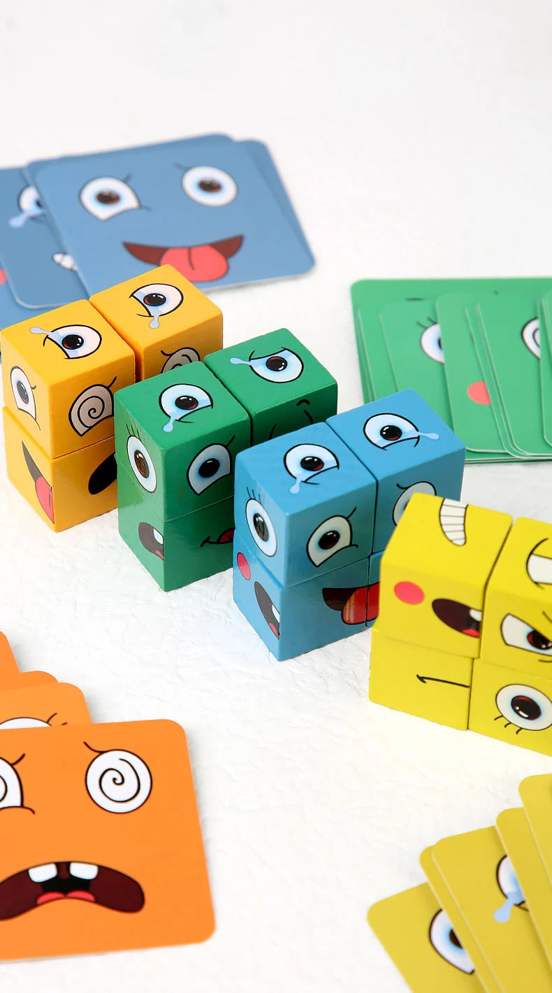 A collection of wooden face-changing cube puzzle toys in various colors like blue, yellow, and green are scattered on a white