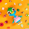 A collection of colorful animal-themed building blocks scattered on an orange background.