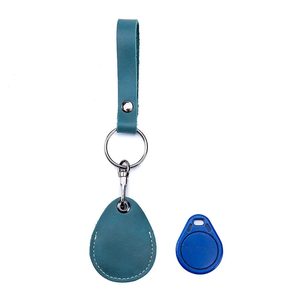 A teal leather key wallet with a loop and a separate blue silicone key fob.