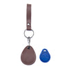 A brown leather key wallet with a metal ring and a blue tag is shown against a white background.