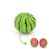 A green wooden fruit toy with black stripes, resembling a watermelon slice.