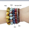 A bracelet featuring a gradient of natural sea sediment and turquoise beads, showing various sizes.