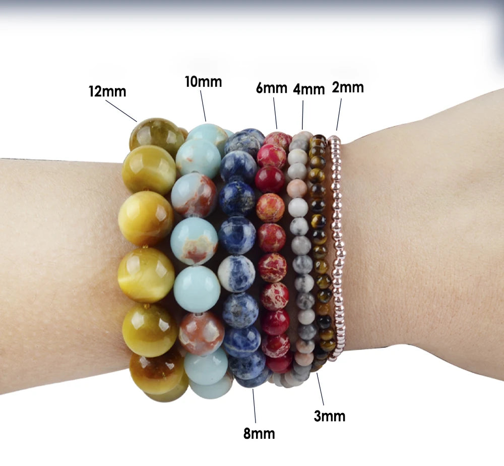 A bracelet featuring a gradient of natural sea sediment and turquoise beads, showing various sizes.