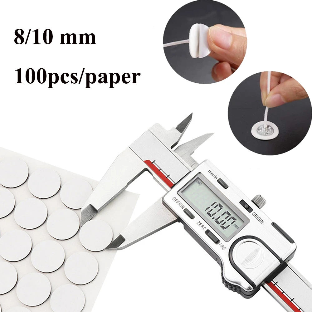 A pair of precision tweezers is shown next to a small white sticker, demonstrating the size and application for candle wick c