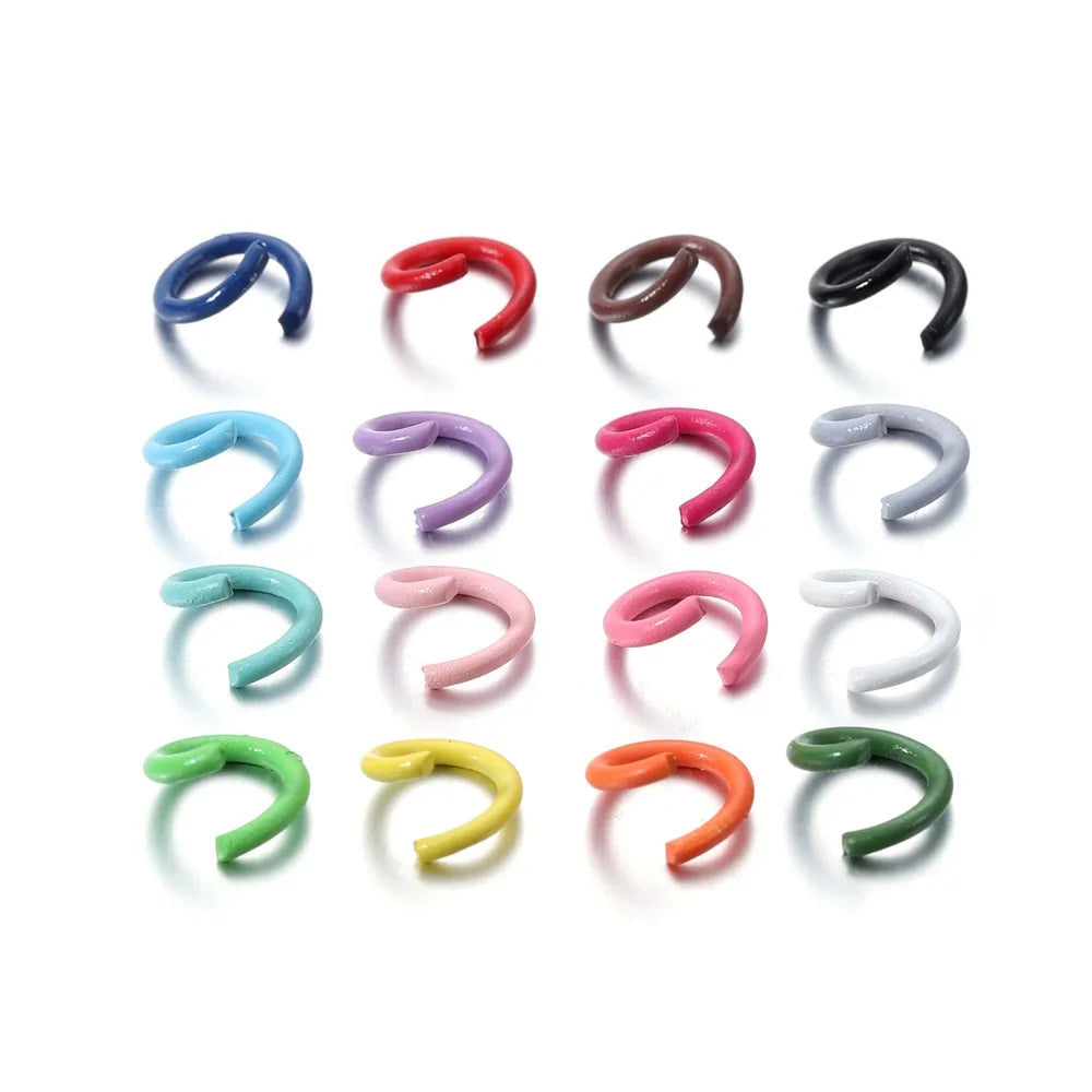 A collection of colorful metal open jump rings in various colors and shapes.