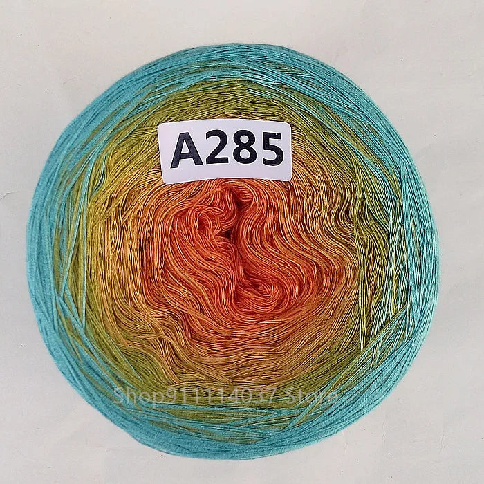 A ball of A285 rainbow gradient mercerized cotton cake yarn