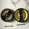 A black circular product kit with yellow accents is shown next to two metal rods.
