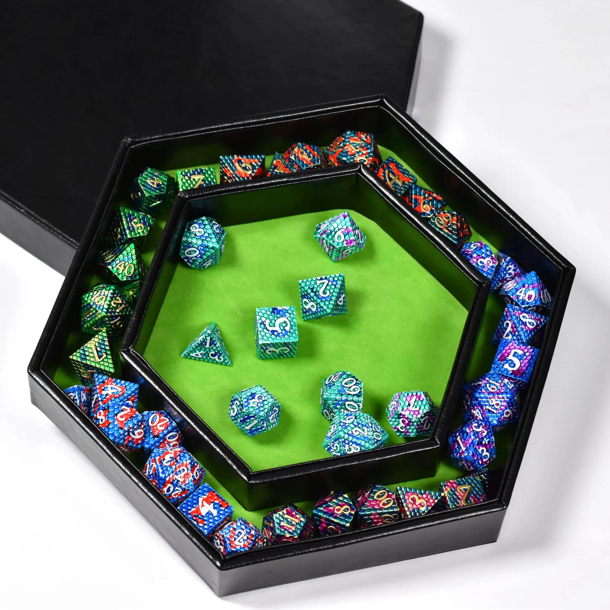 A hexagonal dice tray with a velvet green interior filled with colorful dice and a black storage box.