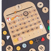 A wooden daily calendar board showing various dates, weather icons, and months for learning.