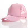 A pink trucker hat with a mesh back and a curved brim is shown on a reflective surface.