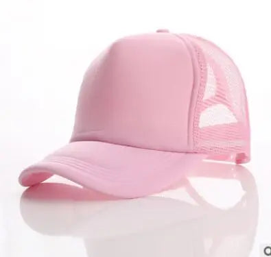 A pink trucker hat with a mesh back and a curved brim is shown on a reflective surface.