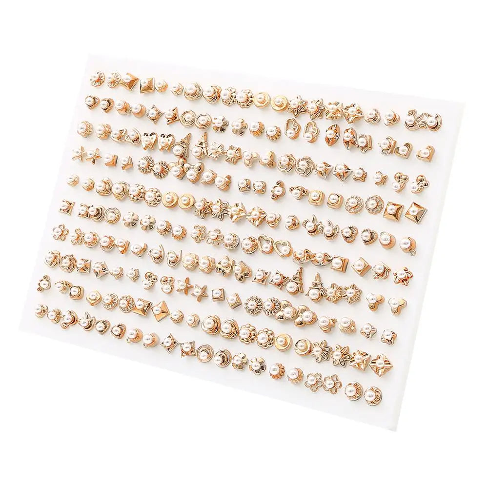 A display of assorted acrylic stud earrings including hearts, stars, and moons in gold tone.
