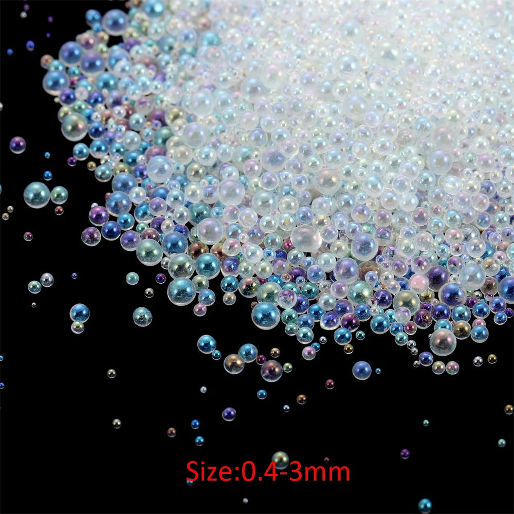 A pile of iridescent glass bubble beads ranging in size from 0.4 to 3mm.