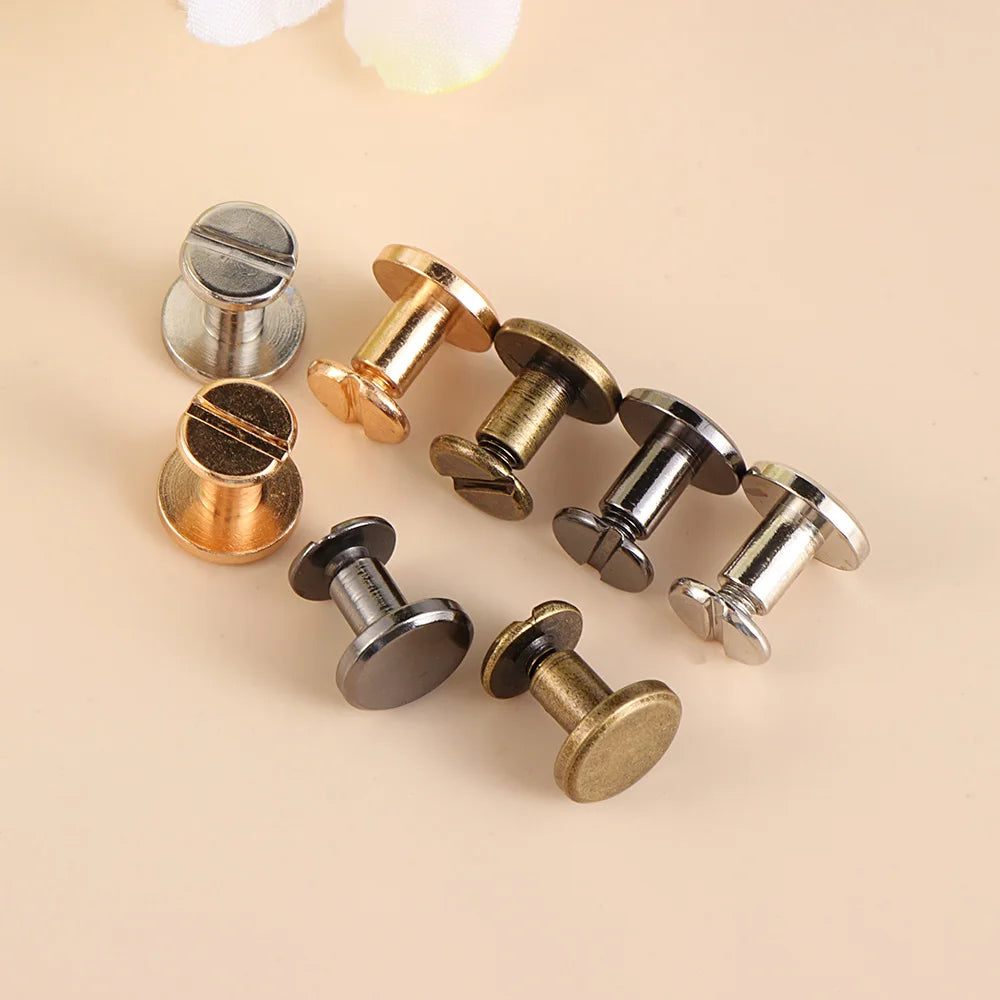 A collection of decorative heart brass rivets in various finishes, including silver and gold tones.