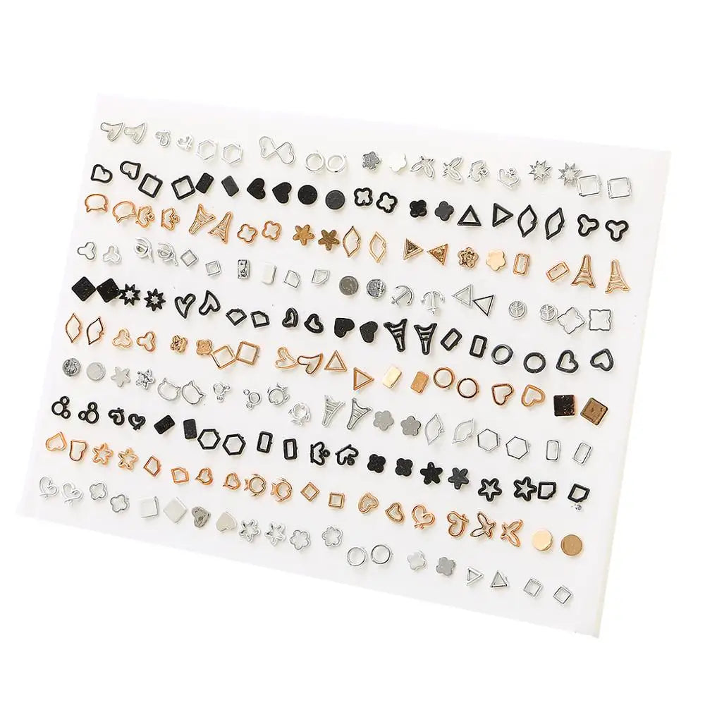 A collection of assorted acrylic stud earrings featuring various shapes like hearts, stars, and moons arranged on a white sur