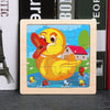 A wooden jigsaw puzzle featuring a yellow duck and several small fish on a blue background.