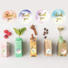 A collection of round, colorful thank you stickers in various shades of pink, purple, and green on a white background.