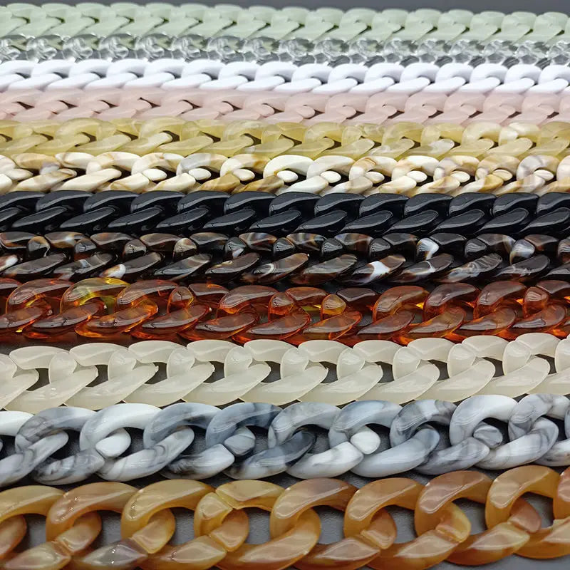 A collection of acrylic bag chain straps in various colors including white, beige, gold, black, and amber tones.