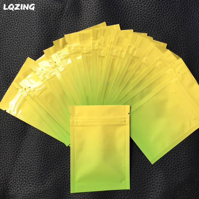 A fan of clear yellow plastic bags, some stacked and one displayed, against a dark background.
