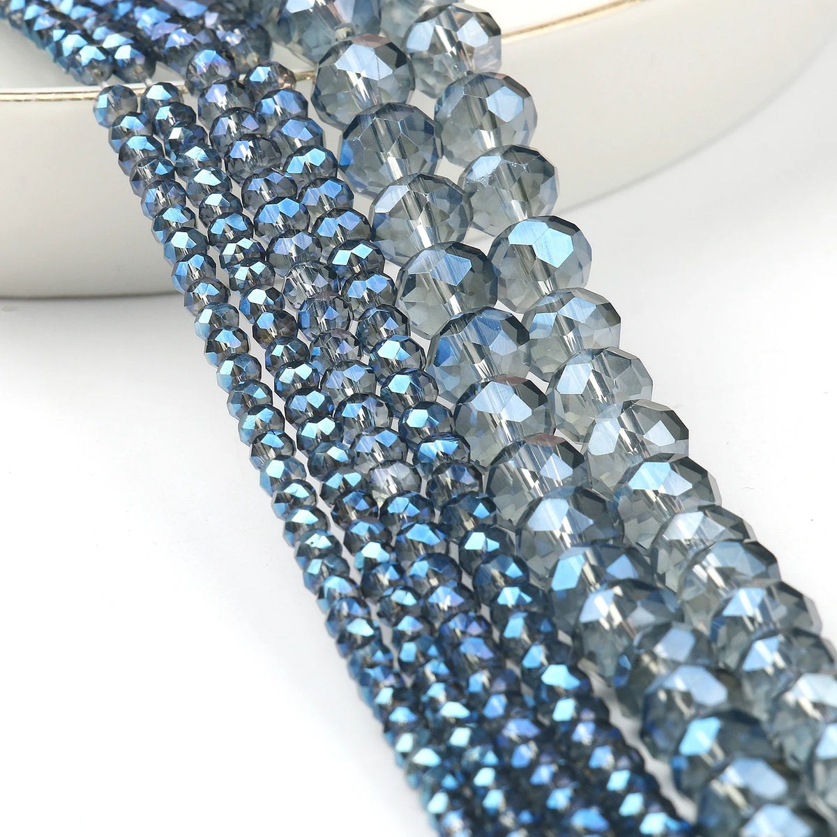 Close-up of a strand of faceted blue crystal glass beads for jewelry making