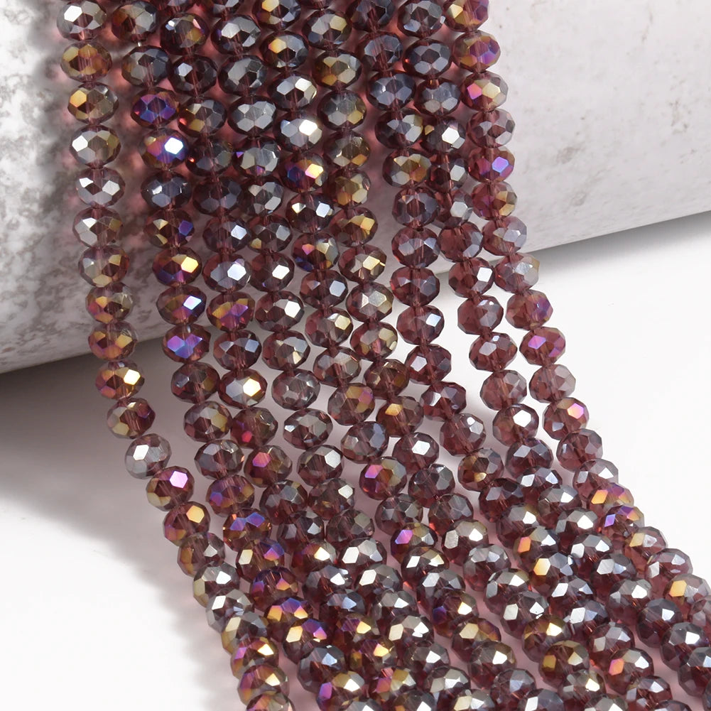 A close-up of reddish-brown faceted crystal glass beads strung together on a string.