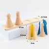 A wooden Montessori math learning set featuring spindle shapes and geometric pieces displayed on a light wooden board.