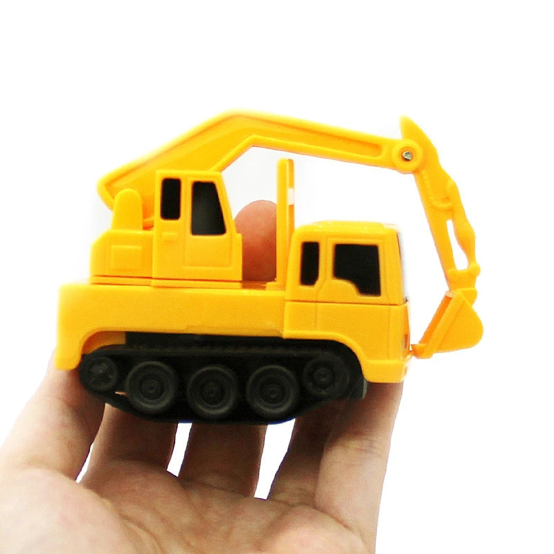A yellow line-following robot car toy with a yellow plastic arm is held in a hand.
