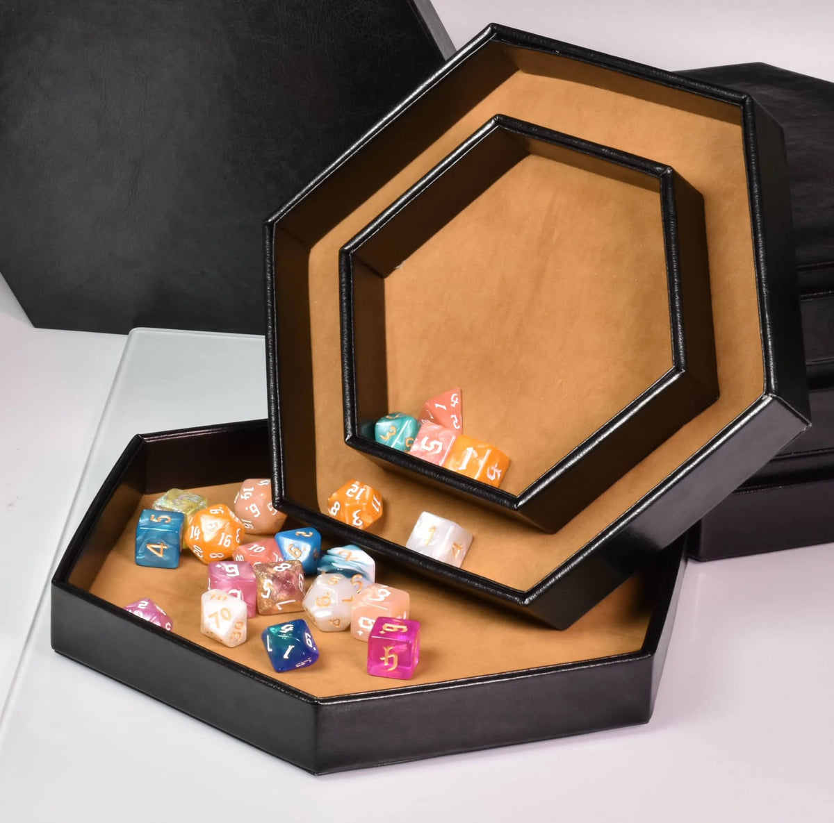 A hexagonal storage box with a velvet interior displaying colorful dice.