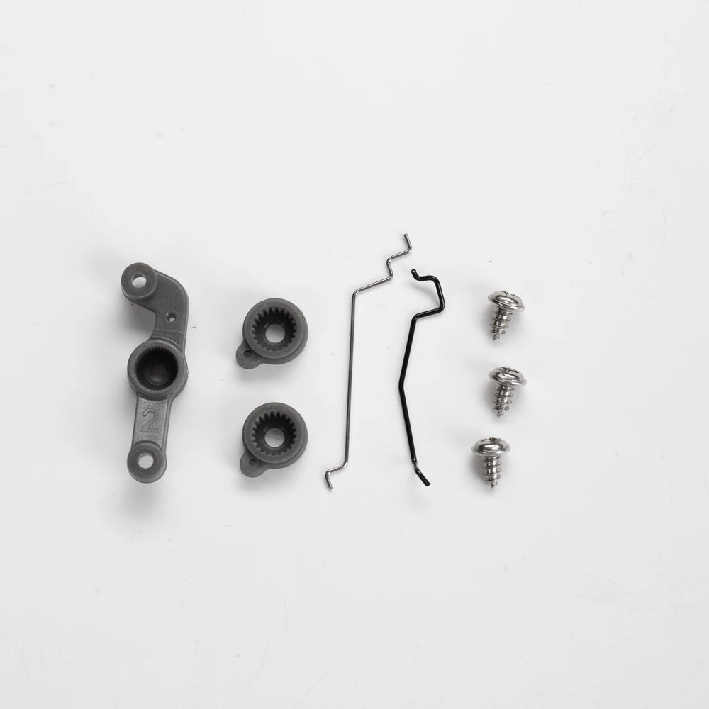 A set of 1:12 scale RC car steering wheel and interior upgrade parts including a mounting piece, a gear, and several small sc