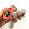 A hand holds several soft foam dart refills in red and gray packaging.