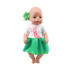 A handmade doll dress for an 18-inch American Girl doll featuring a pink giraffe print and a green skirt.