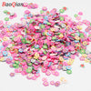 A pile of colorful soft polymer clay slices in various shades of pink, green, and blue for nail art and DIY crafts.