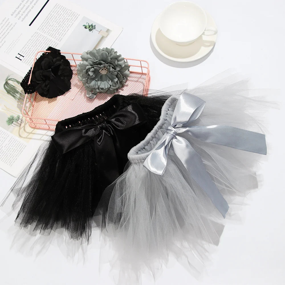 A black and gray tulle tutu dress set for a baby girl with a silver bow and crown headband.