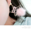 Gold-toned star-shaped earring featuring a pink rectangular charm with the text ROIDA'L and a fluffy pink mink fur pom pom