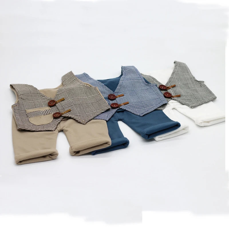 A set of newborn photography outfits featuring plaid vests and matching trousers in various neutral tones.