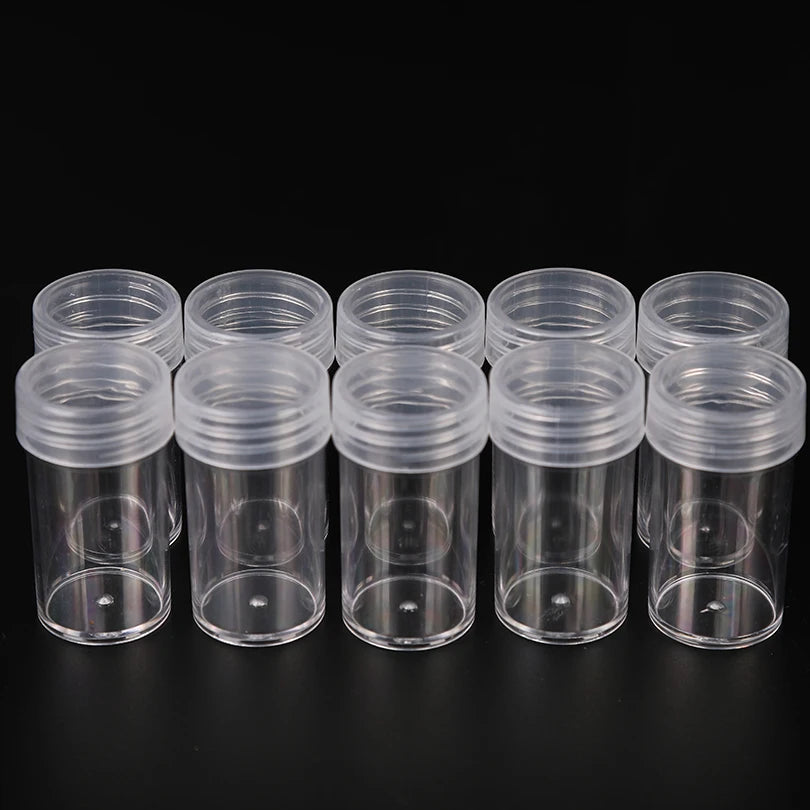 A row of clear plastic storage bottles with screw caps arranged horizontally on a dark surface.